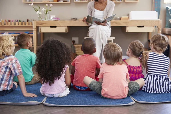 depositphotos_156590634-stock-photo-teacher-at-montessori-school-with